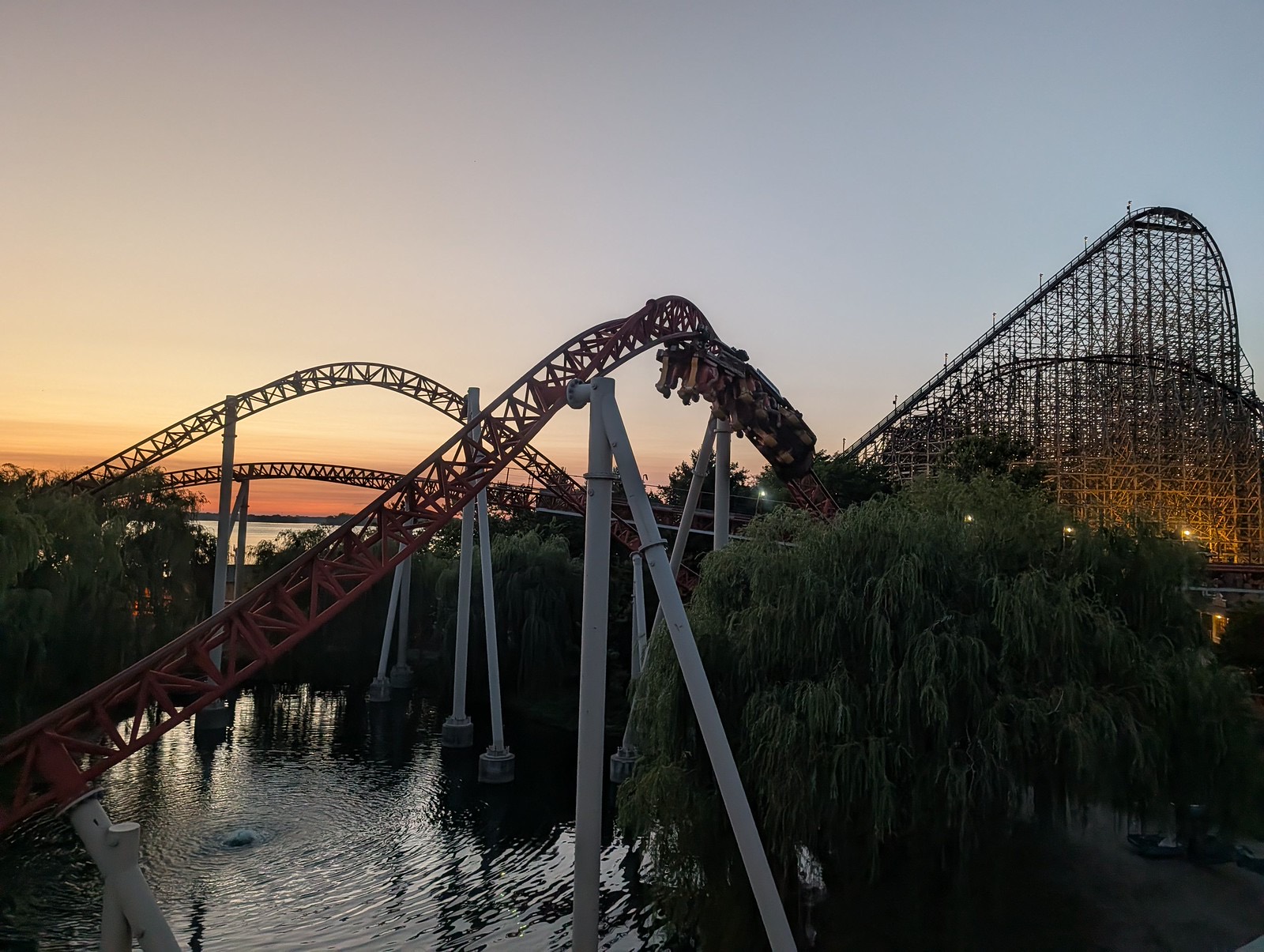 Maverick over the lagoon at dusk with Steel Vengeance in the background at Cedar Point