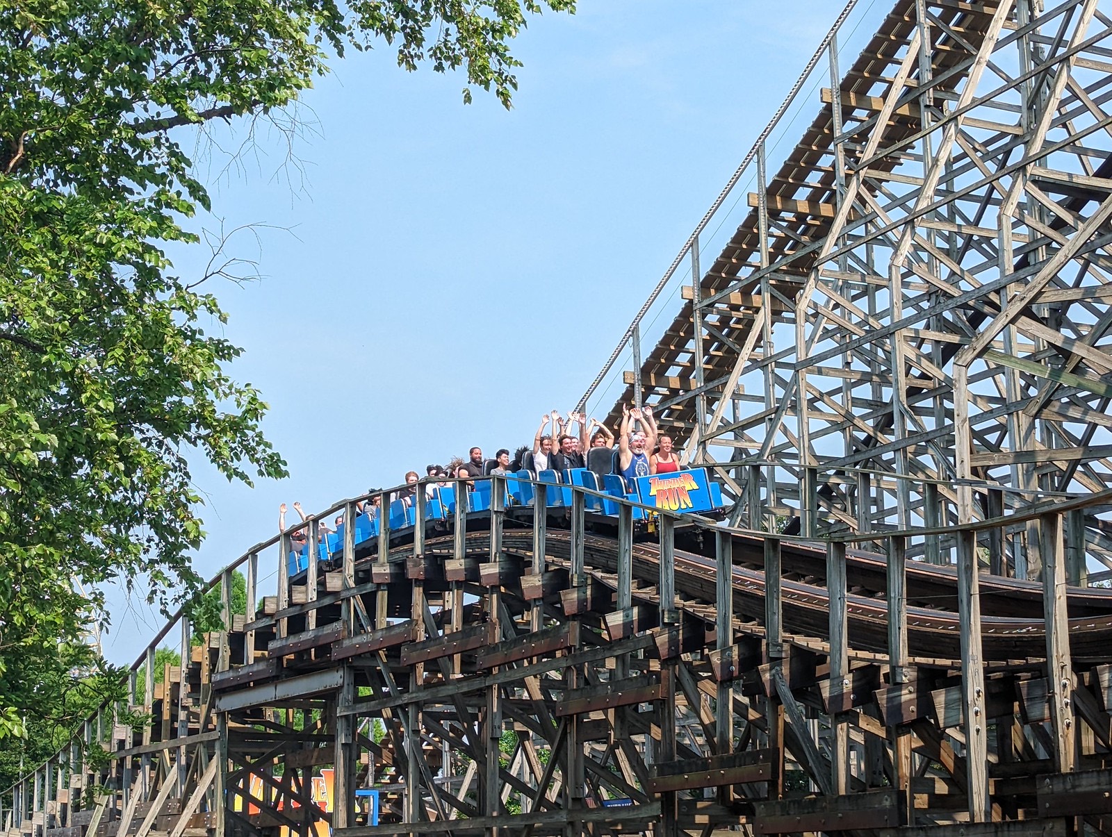 Thunder Run wooden coaster train with riders' arms up at Kentucky Kingdom